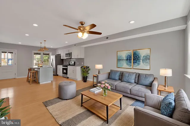 a kitchen with kitchen island granite countertop stainless steel appliances a stove sink and microwave