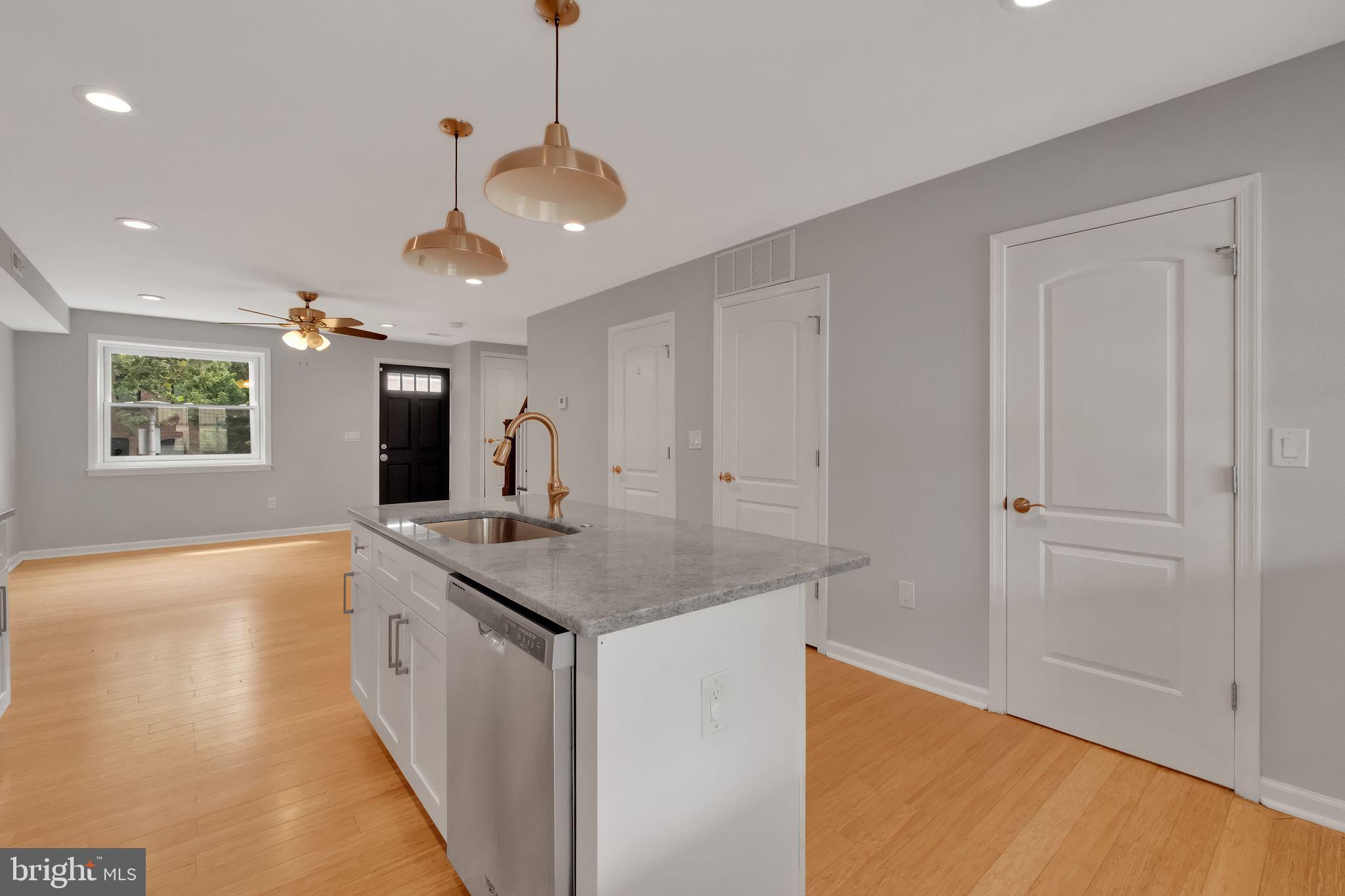 245 South Clinton Street Baltimore, MD 21224 - Photo 7 of 39 a spacious bathroom with a granite countertop sink a mirror and a bathtub