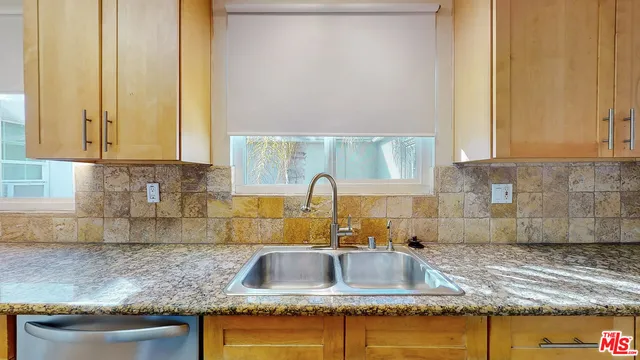 a kitchen with sink cabinets and window