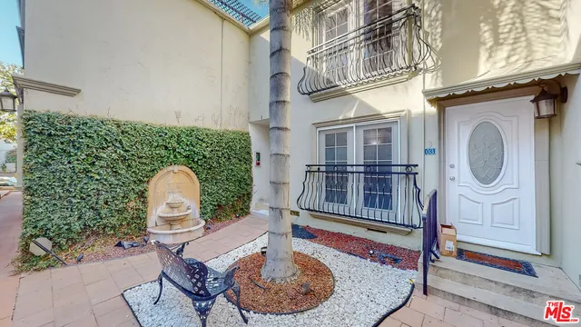 a view of a house with wooden walls and a potted plant