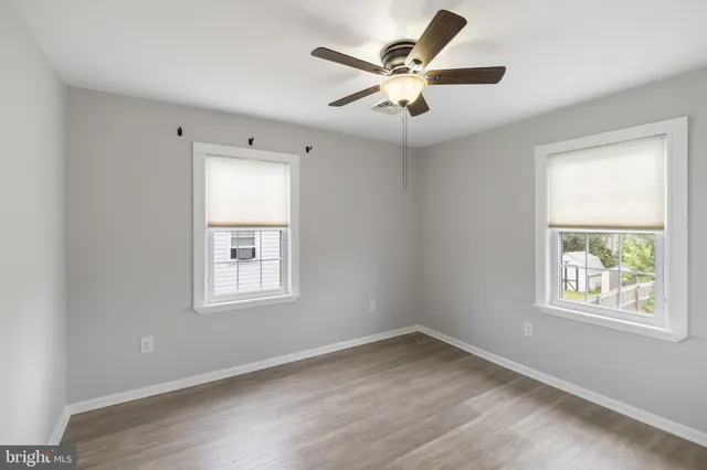 wooden floor in an empty room with a window