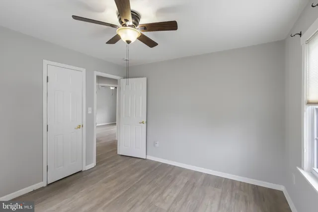 a view of an empty room and wooden floor