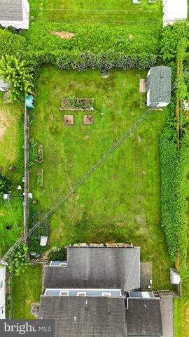 an aerial view of a house with a yard and lake view