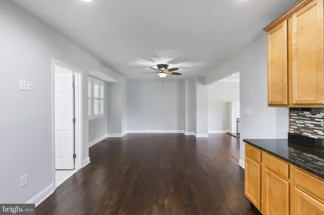 a view of a kitchen with wooden floor and a sink