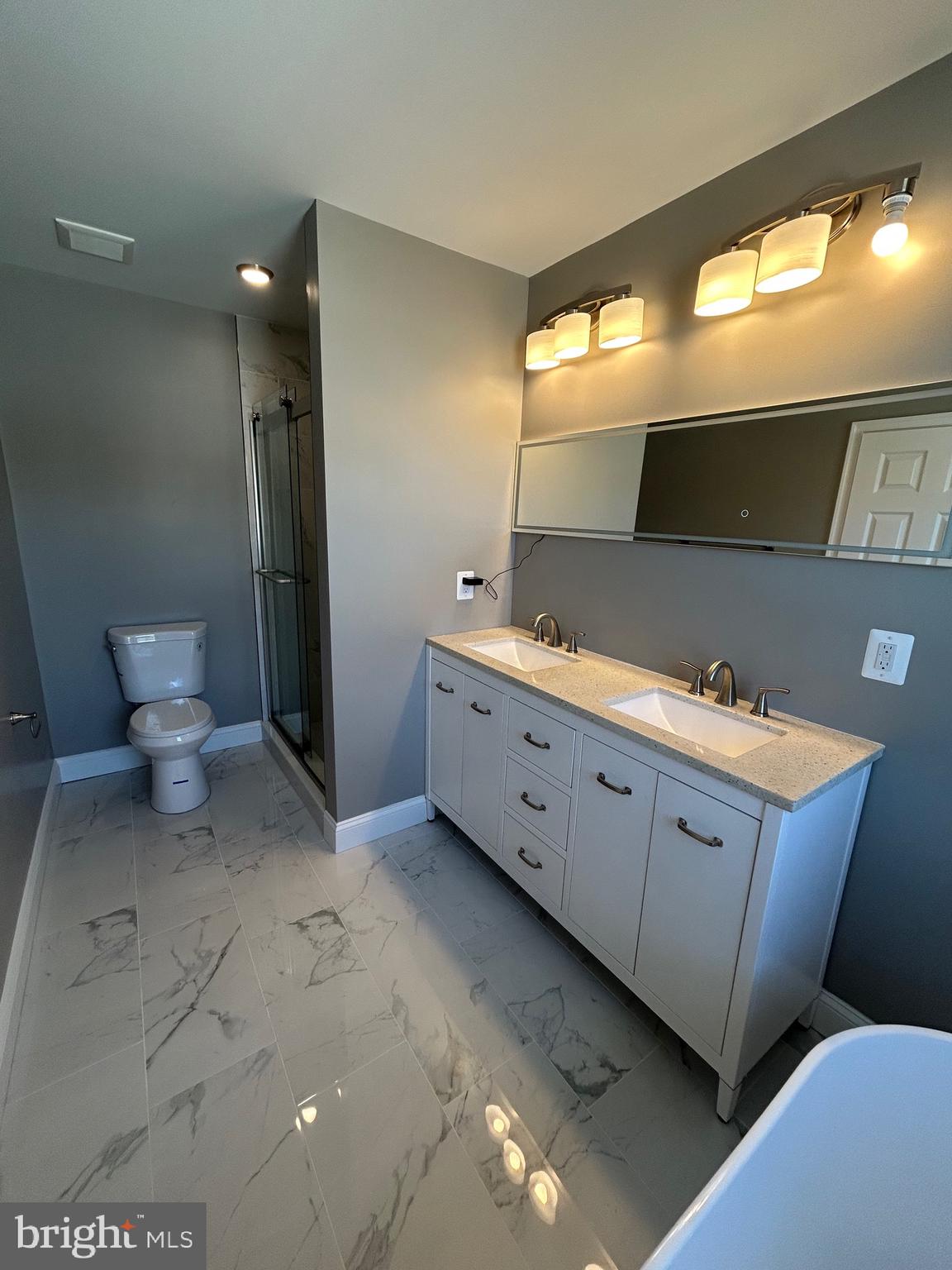 4739 Witchhazel Way Aberdeen, MD 21001 - Photo 14 of 32 a spacious bathroom with a double vanity sink and a mirror