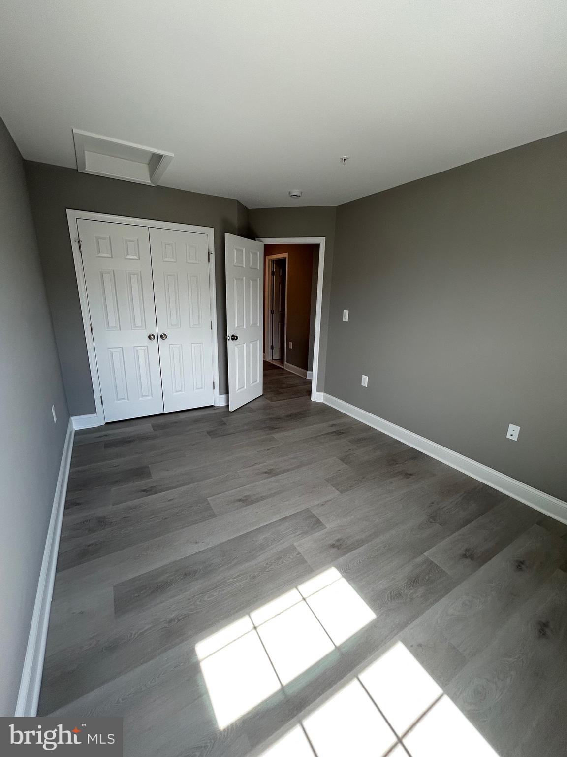 4739 Witchhazel Way Aberdeen, MD 21001 - Photo 16 of 32 an empty room with wooden floor and windows