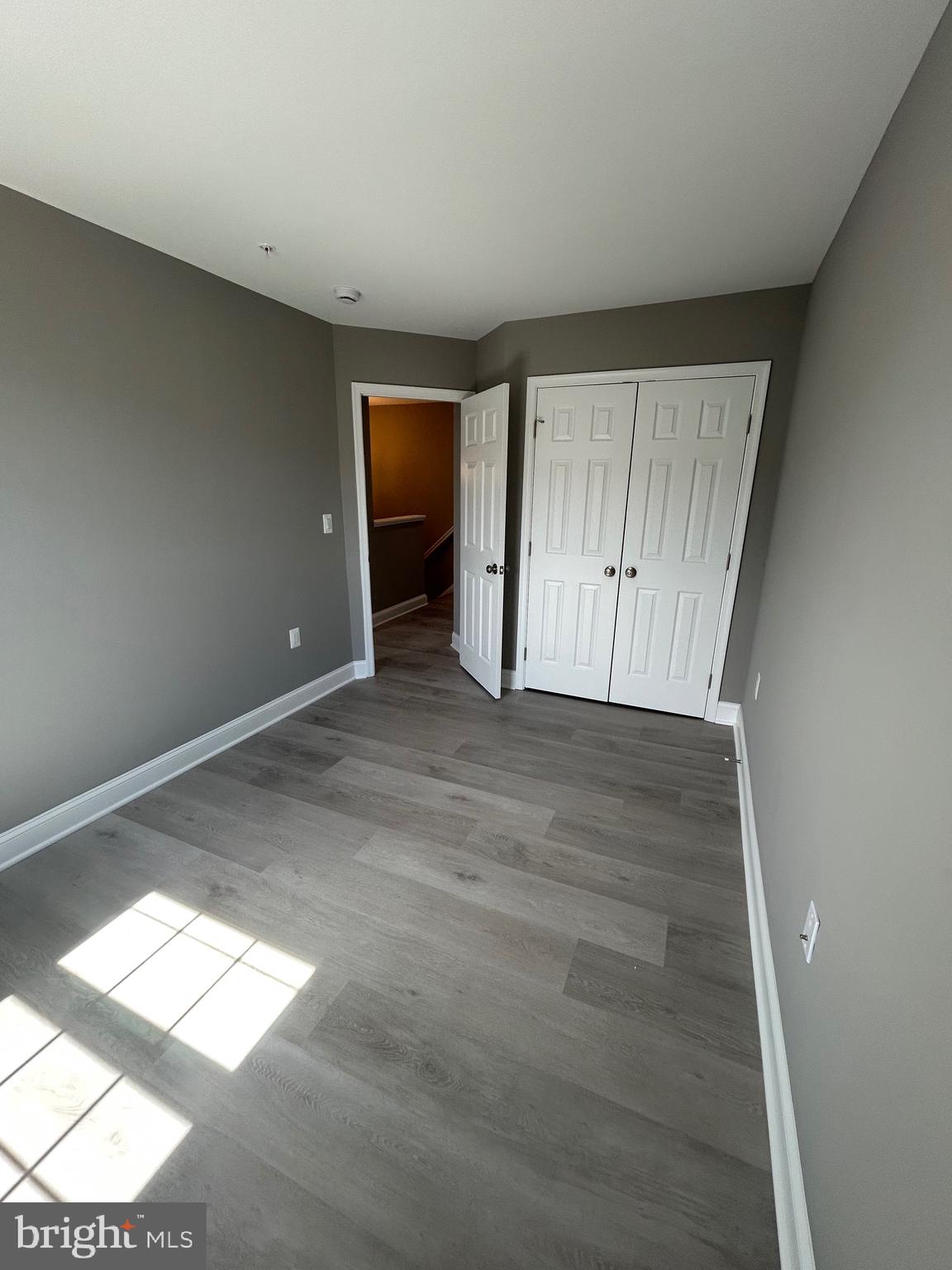 4739 Witchhazel Way Aberdeen, MD 21001 - Photo 18 of 32 an empty room with wooden floor and windows