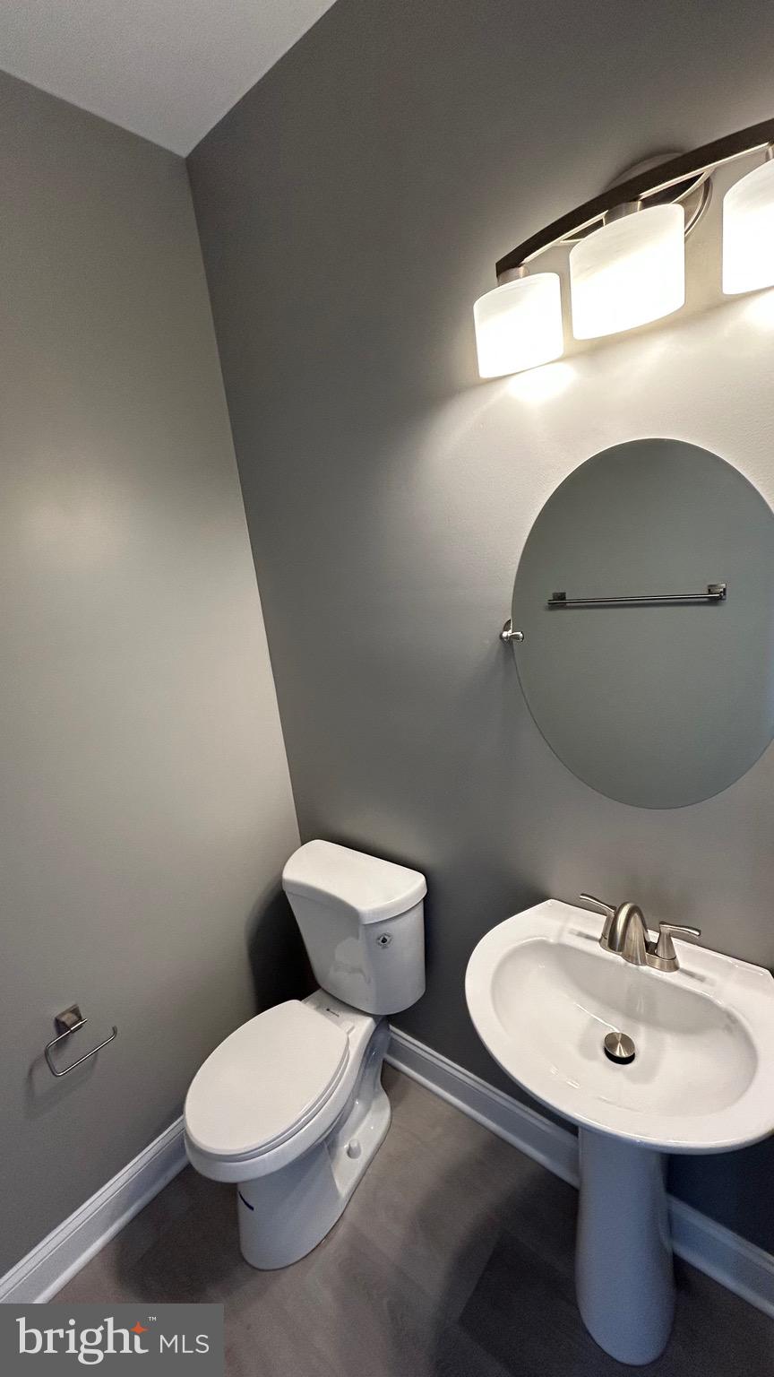 4739 Witchhazel Way Aberdeen, MD 21001 - Photo 23 of 32 a bathroom with a toilet a sink and mirror