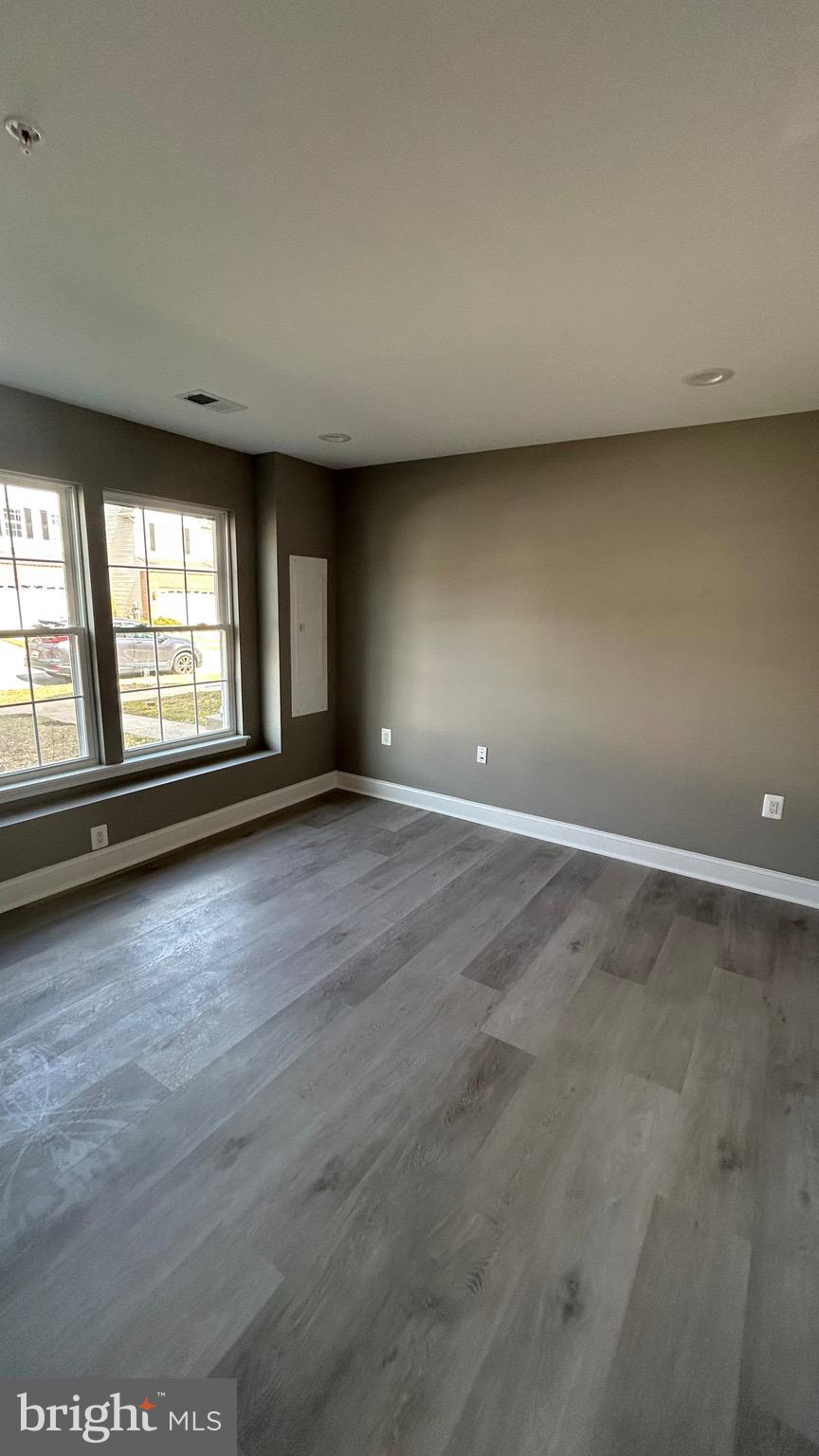 4739 Witchhazel Way Aberdeen, MD 21001 - Photo 26 of 32 an empty room with wooden floor and windows
