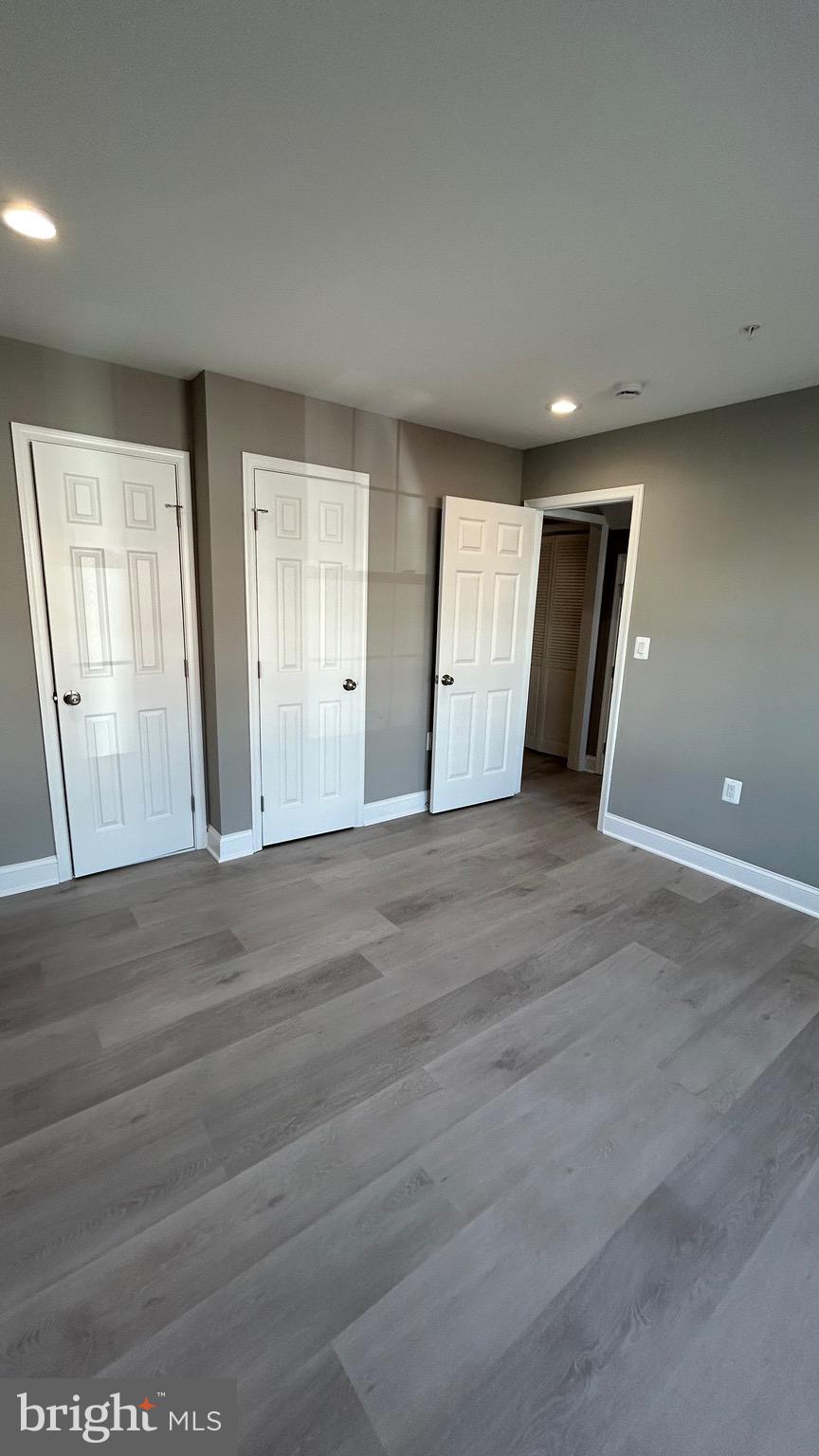 4739 Witchhazel Way Aberdeen, MD 21001 - Photo 27 of 32 a view of an empty room with wooden floor and windows