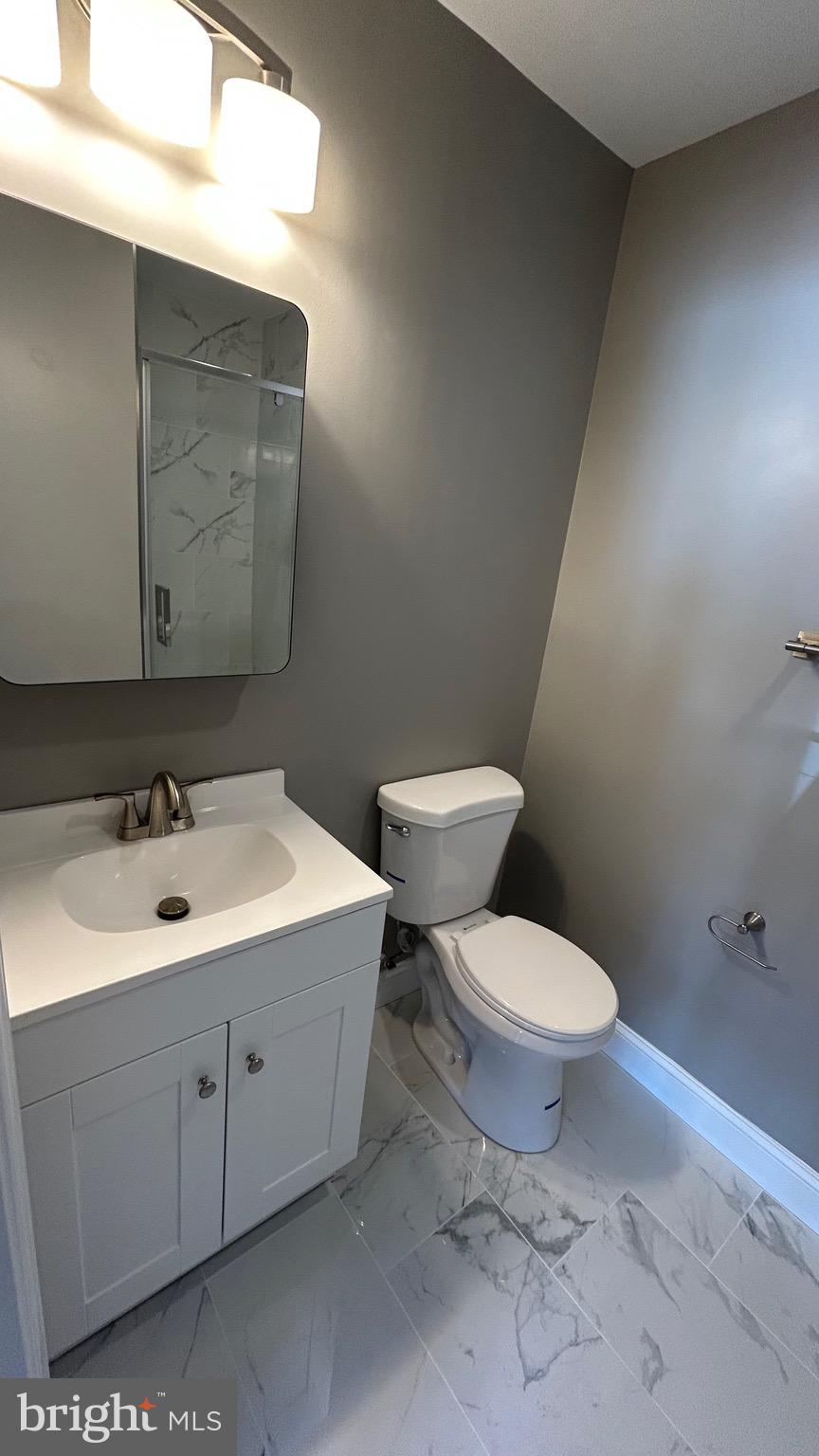 4739 Witchhazel Way Aberdeen, MD 21001 - Photo 29 of 32 a bathroom with a toilet sink and mirror