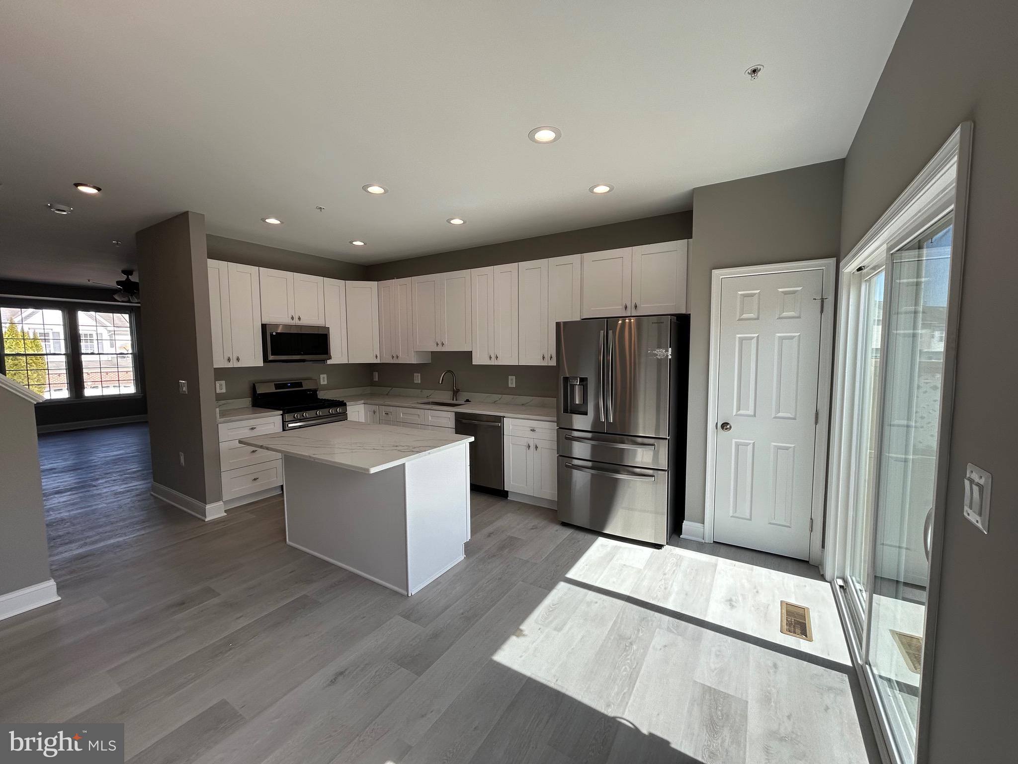 4739 Witchhazel Way Aberdeen, MD 21001 - Photo 4 of 32 a kitchen with stainless steel appliances kitchen island granite countertop a refrigerator and a stove top oven