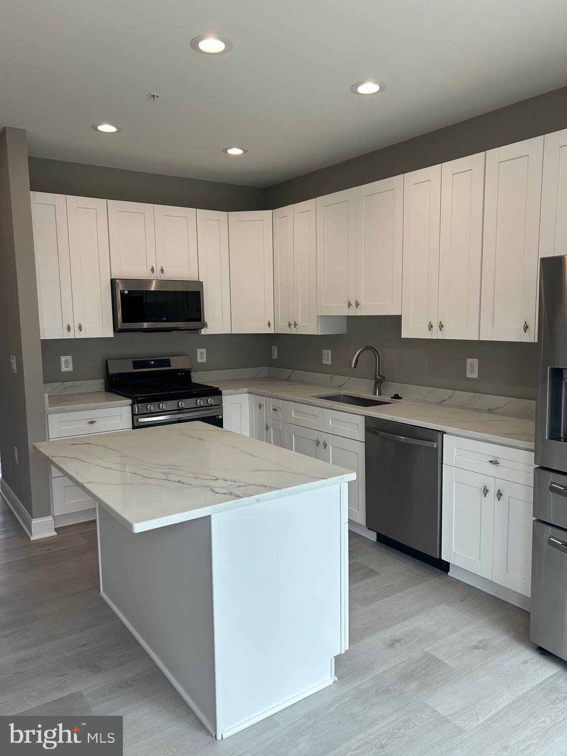 4739 Witchhazel Way Aberdeen, MD 21001 - Photo 5 of 32 a kitchen with granite countertop a sink a stove and cabinets