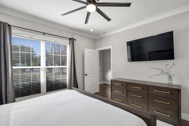 a bedroom with a bed and a flat screen tv