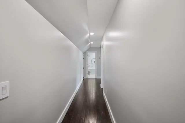 a view of hallway with wooden floor