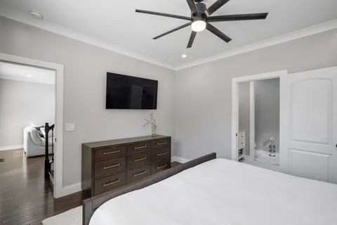 a bedroom with a bed and a flat screen tv