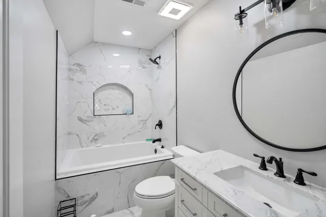 a bathroom with a sink a toilet and a mirror