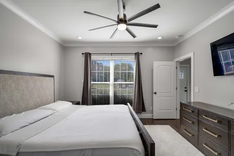 a bedroom with a large bed and a window