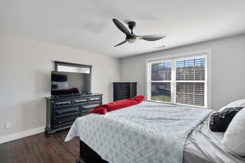 a bedroom with a bed and a flat screen tv