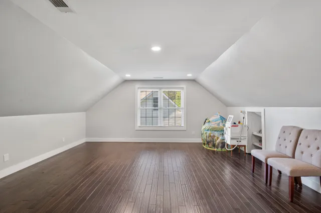 a view of livingroom with furniture wooden floor and windows