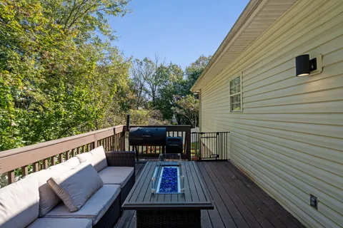 a balcony with wooden floor and furniture