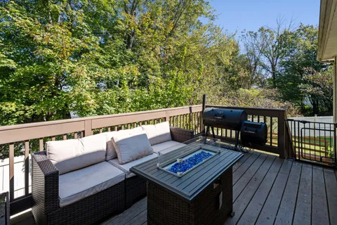 a roof deck with wooden floor and fence