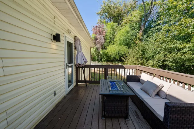a view of balcony with wooden floor and fence