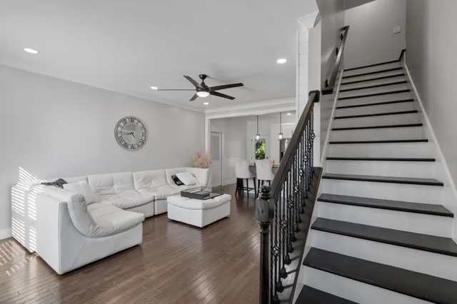 a living room with furniture and stairs