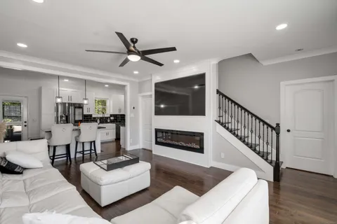 a living room with furniture flat screen tv and a fireplace