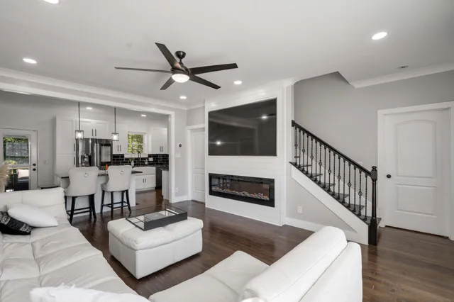 a living room with furniture flat screen tv and a fireplace