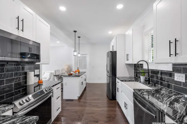 a kitchen with a stove a sink and a refrigerator