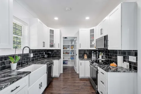 a kitchen with stainless steel appliances granite countertop a stove and a sink