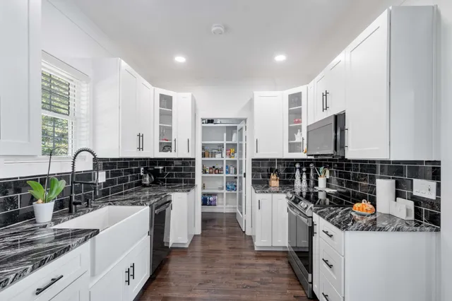 a kitchen with stainless steel appliances granite countertop a stove and a sink