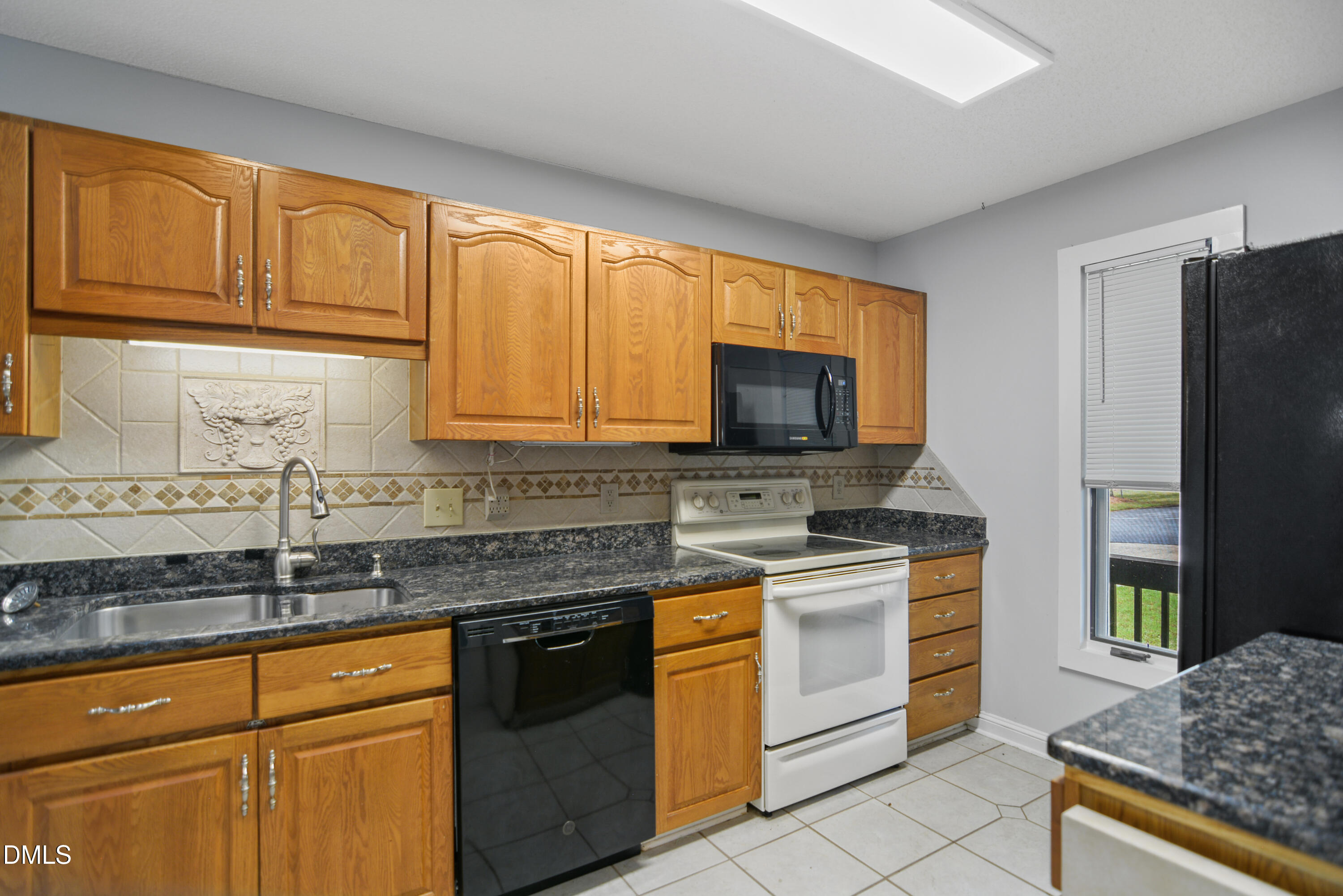 3614 Top Of The Pines Court Raleigh, NC 27604 - Photo 6 of 20 a kitchen with stainless steel appliances granite countertop a stove a sink and a microwave