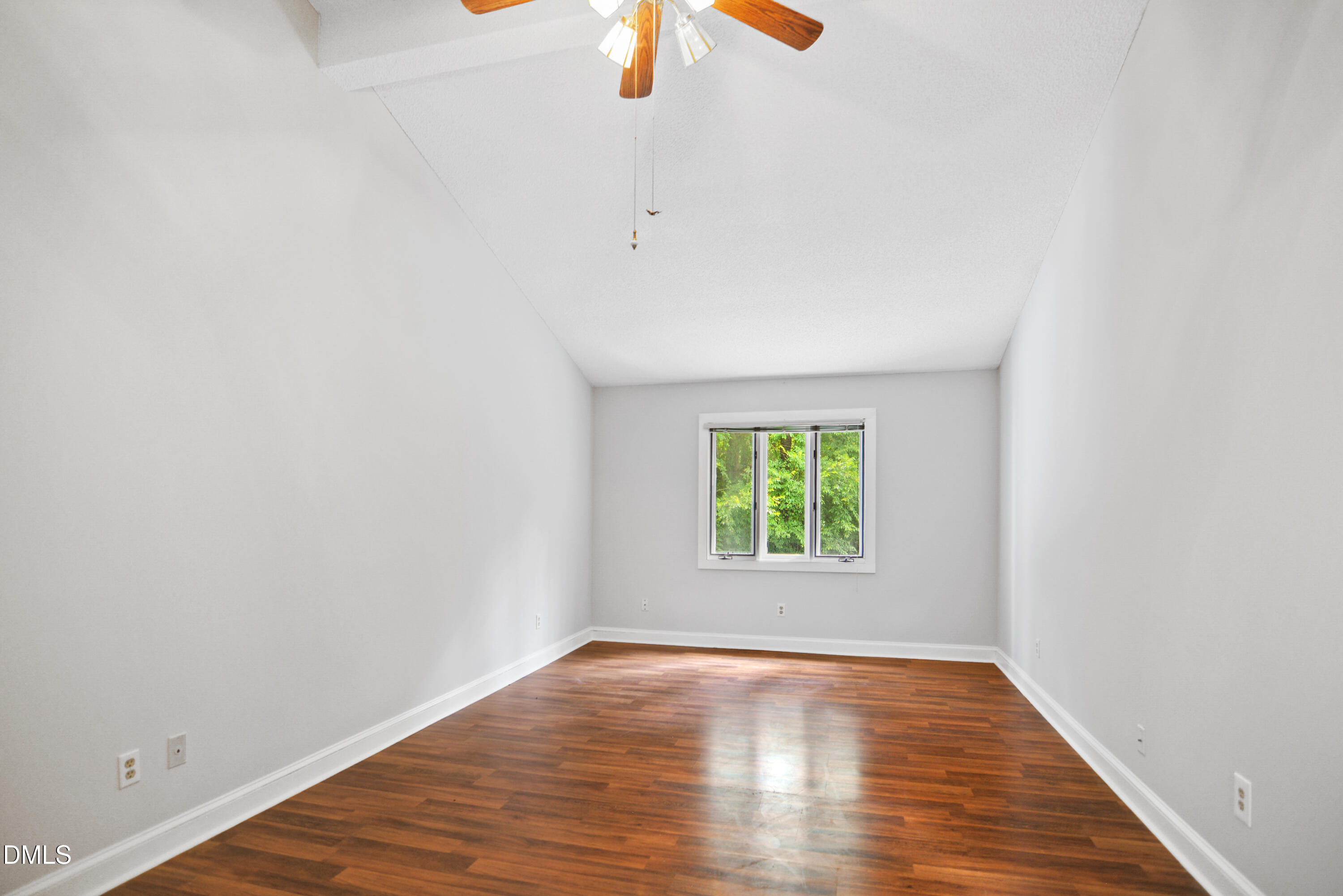 3614 Top Of The Pines Court Raleigh, NC 27604 - Photo 7 of 20 an empty room with a window and a chandelier fan