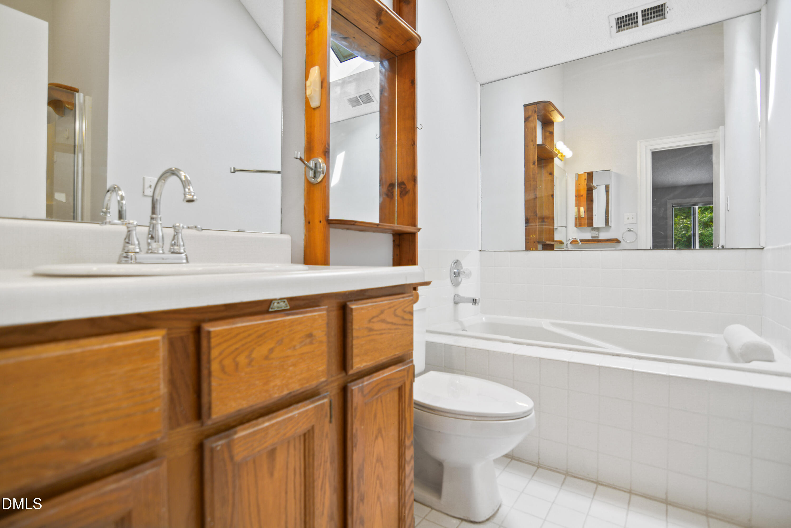 3614 Top Of The Pines Court Raleigh, NC 27604 - Photo 9 of 20 a bathroom with a granite countertop sink toilet a mirror and bathtub