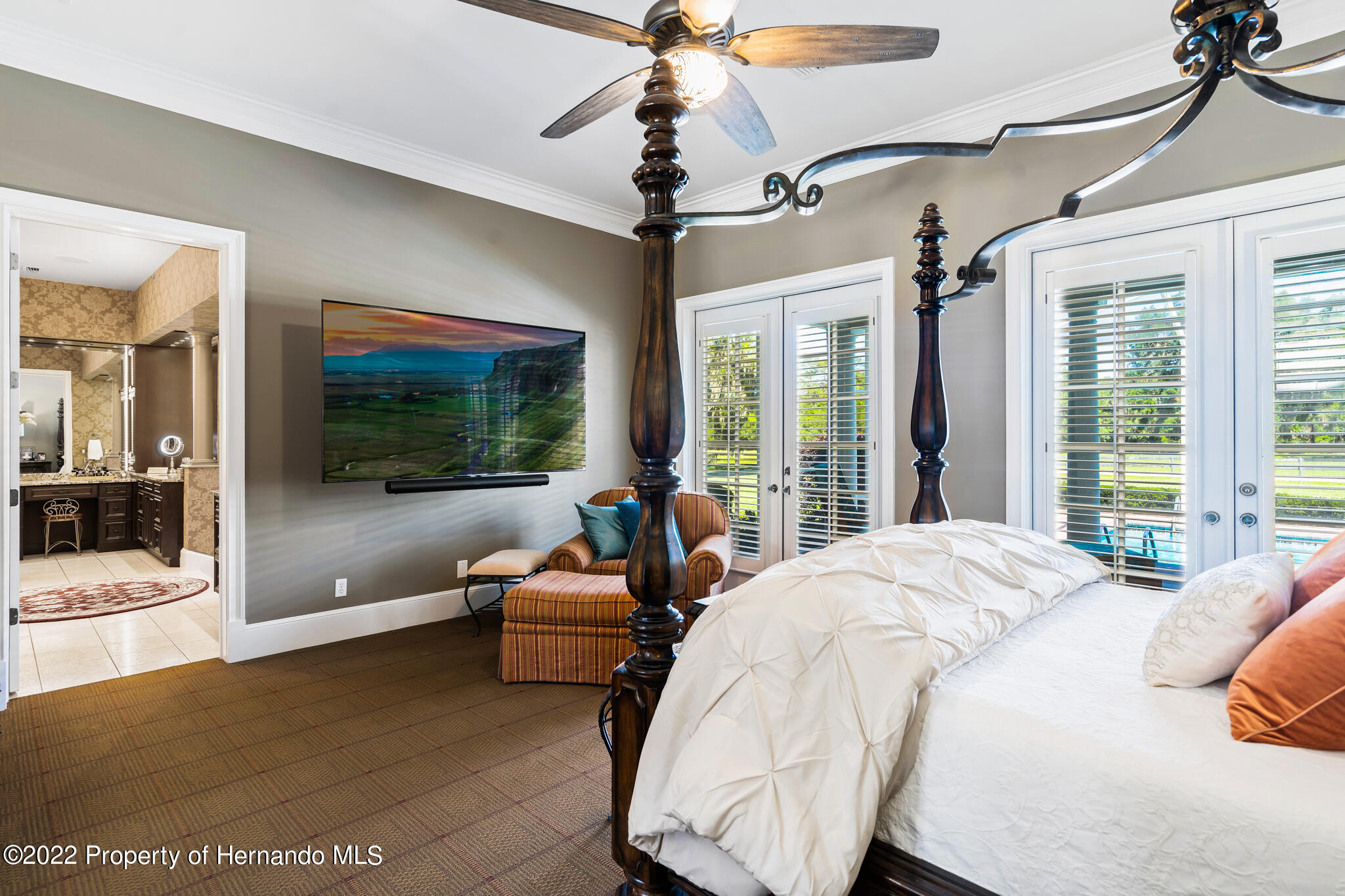 21411 Brookes Run Road Brooksville, FL 34602 - Photo 23 of 62 a bedroom with a large bed and a chandelier