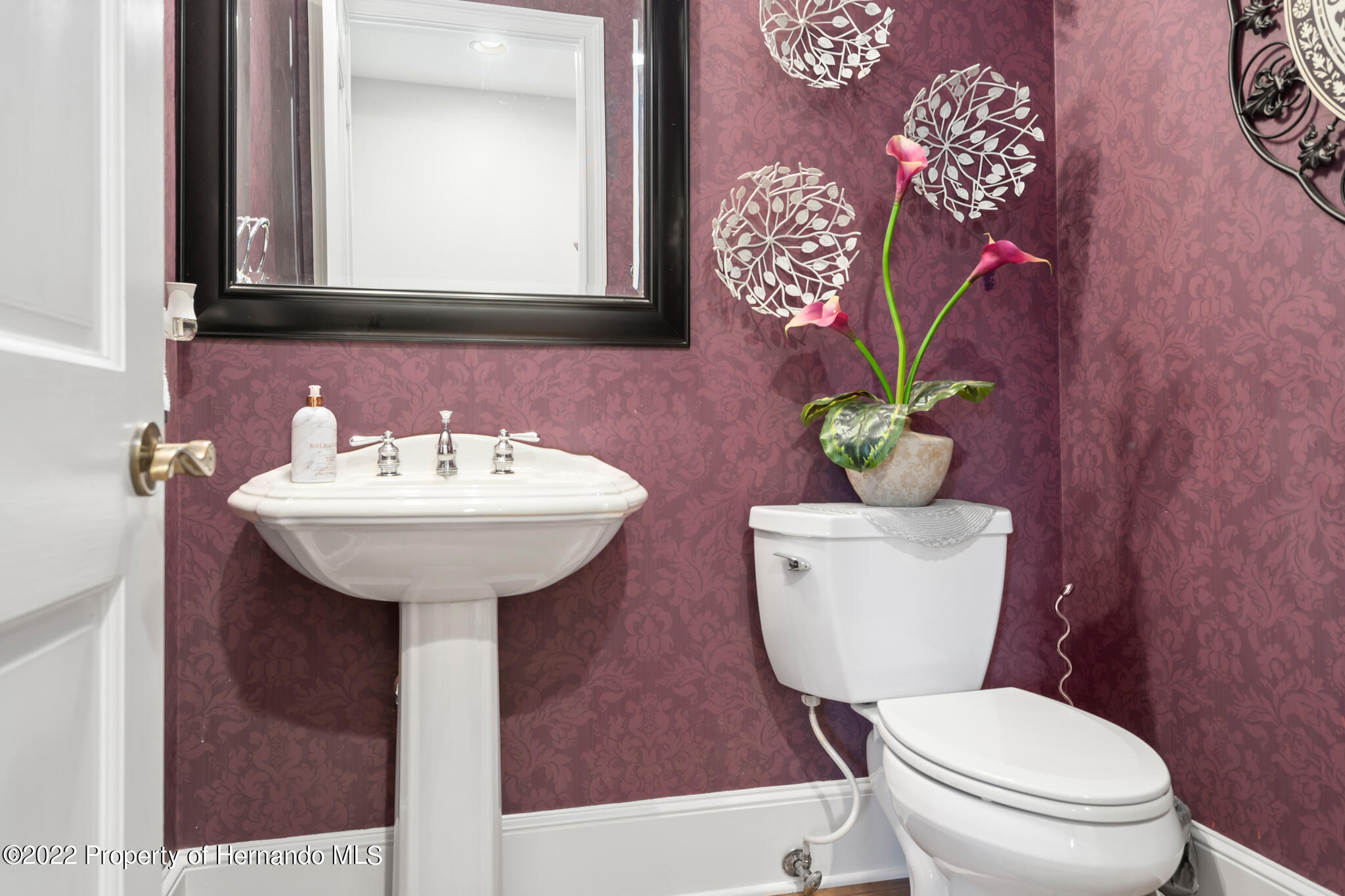 21411 Brookes Run Road Brooksville, FL 34602 - Photo 29 of 62 a bathroom with a toilet sink and mirror