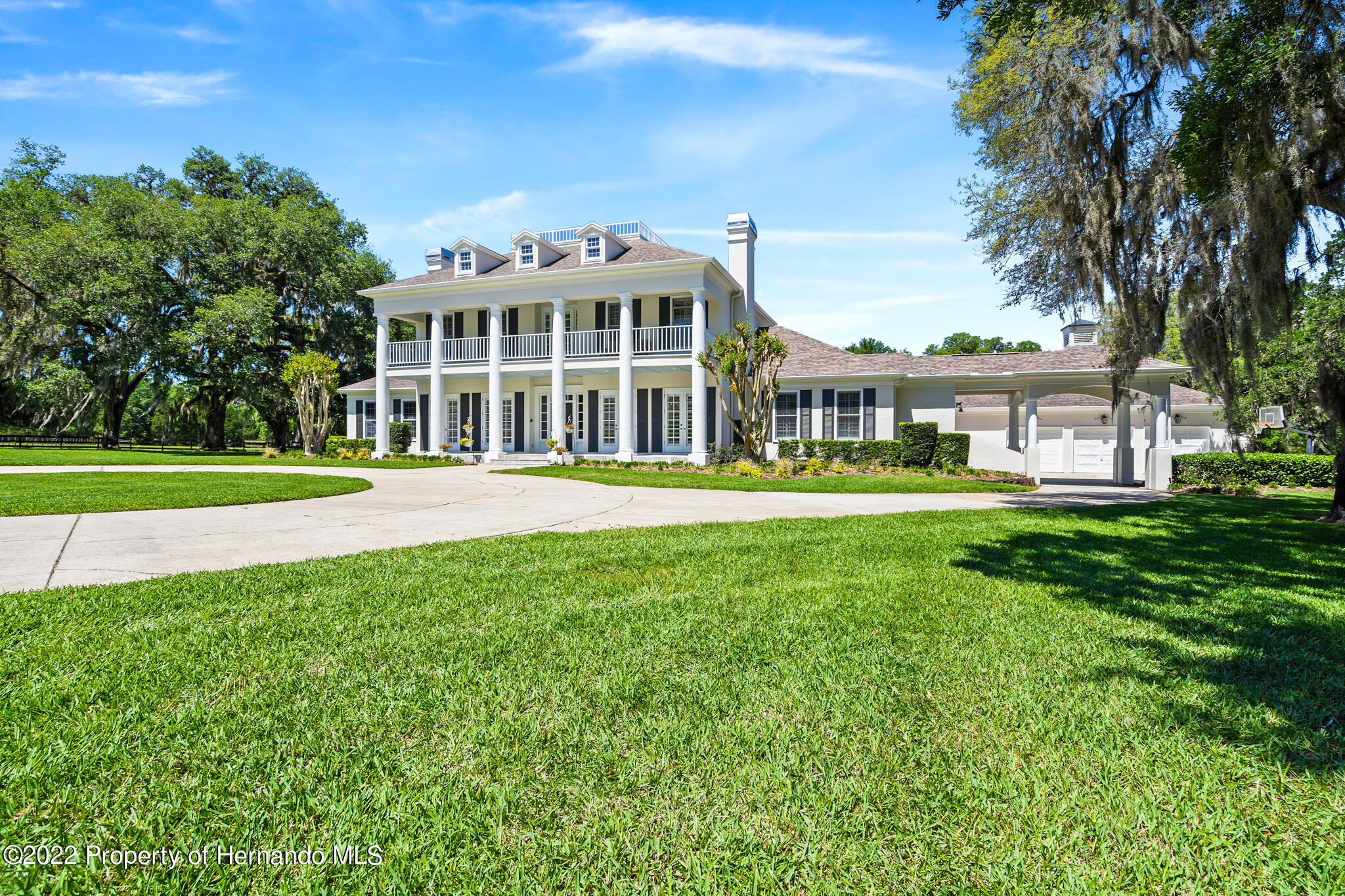 21411 Brookes Run Road Brooksville, FL 34602 - Photo 3 of 62 a front view of a building with a garden