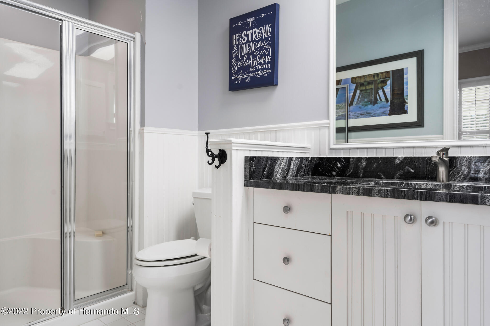 21411 Brookes Run Road Brooksville, FL 34602 - Photo 39 of 62 a bathroom with a toilet a sink and a mirror