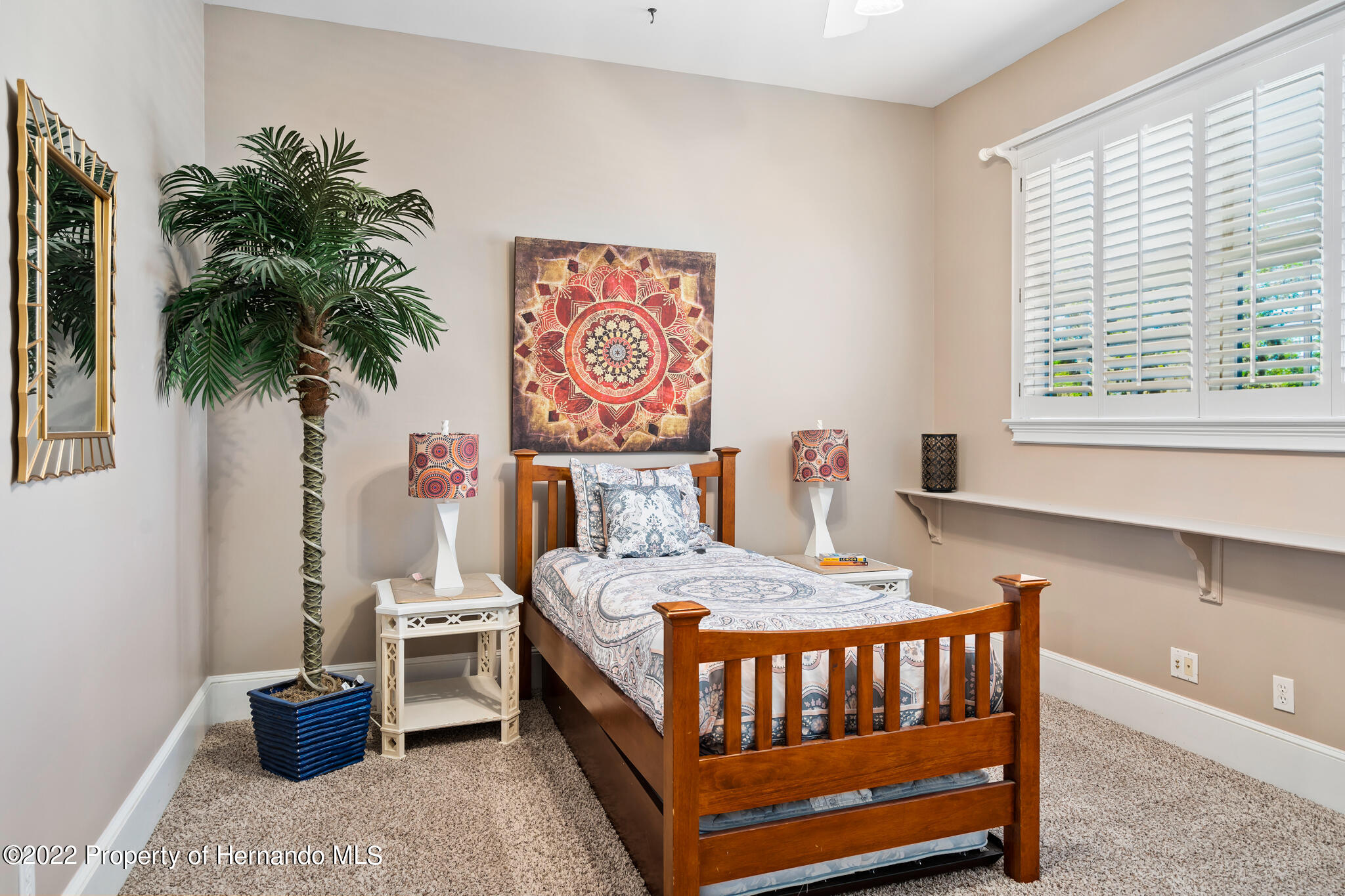 21411 Brookes Run Road Brooksville, FL 34602 - Photo 40 of 62 a bedroom with a bed and a potted plant