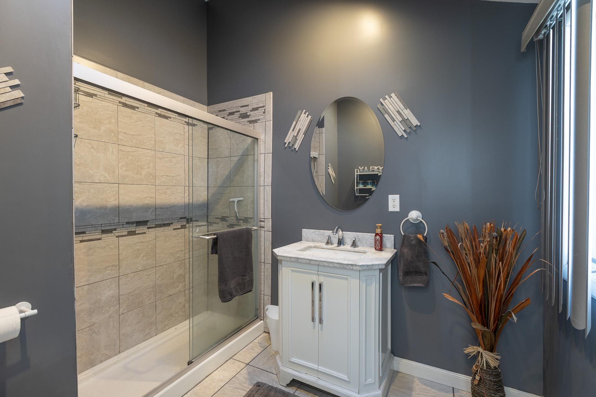 84 Riverside Avenue Mastic Beach, NY 11951 - Photo 11 of 32 Bathroom with vanity, a stall shower, and baseboards
