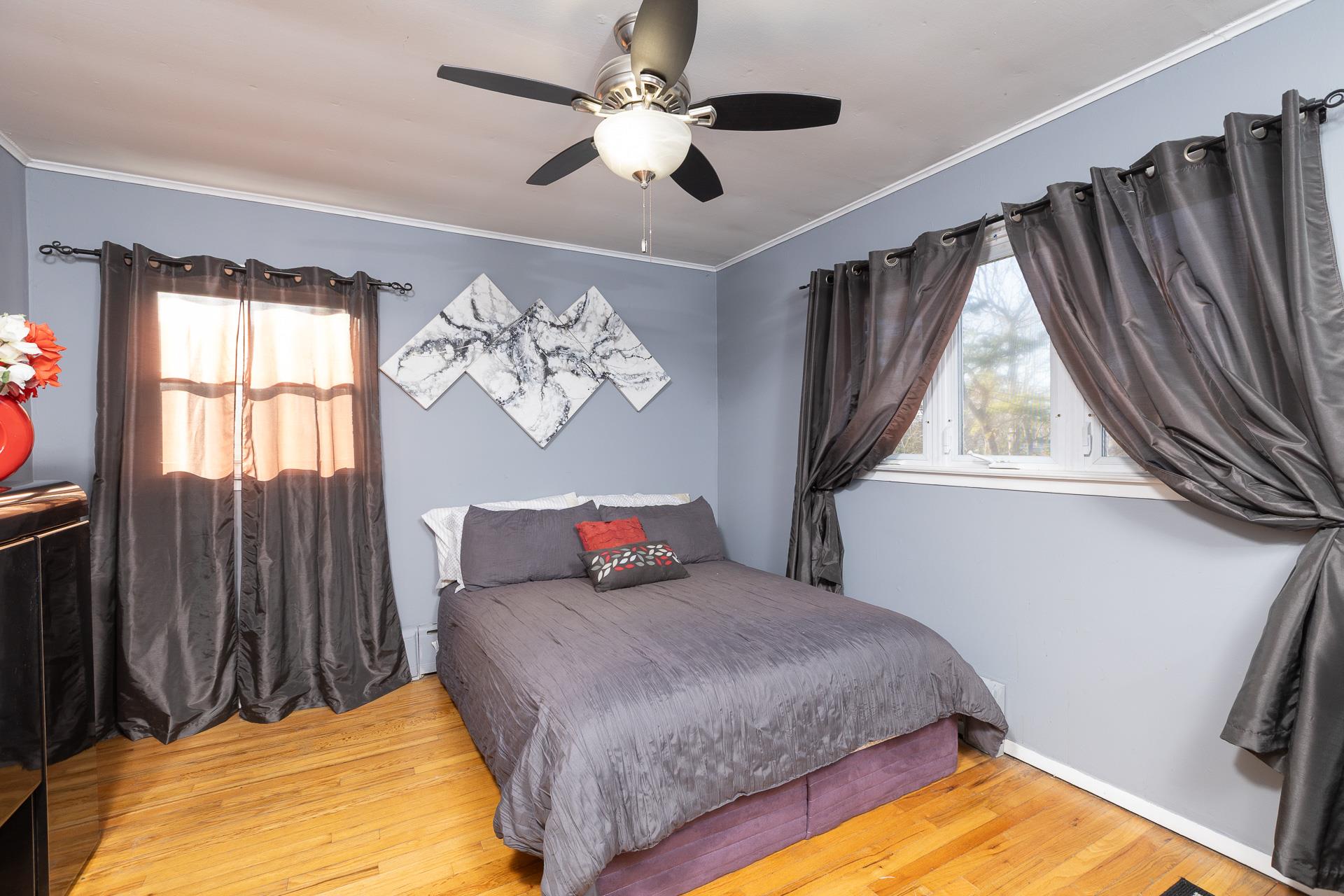 84 Riverside Avenue Mastic Beach, NY 11951 - Photo 13 of 32 Bedroom featuring ornamental molding, wood finished floors, and ceiling fan