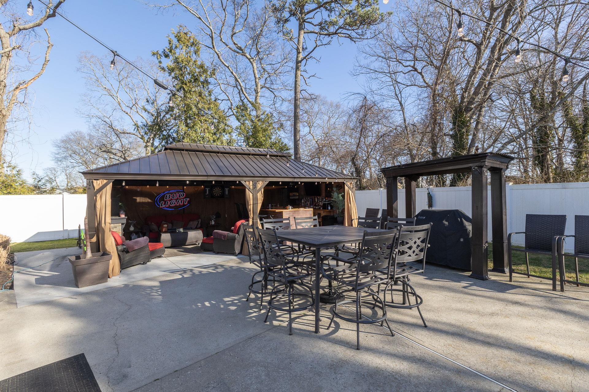 84 Riverside Avenue Mastic Beach, NY 11951 - Photo 23 of 32 View of patio / terrace with outdoor dining space, a fenced backyard, and a gazebo