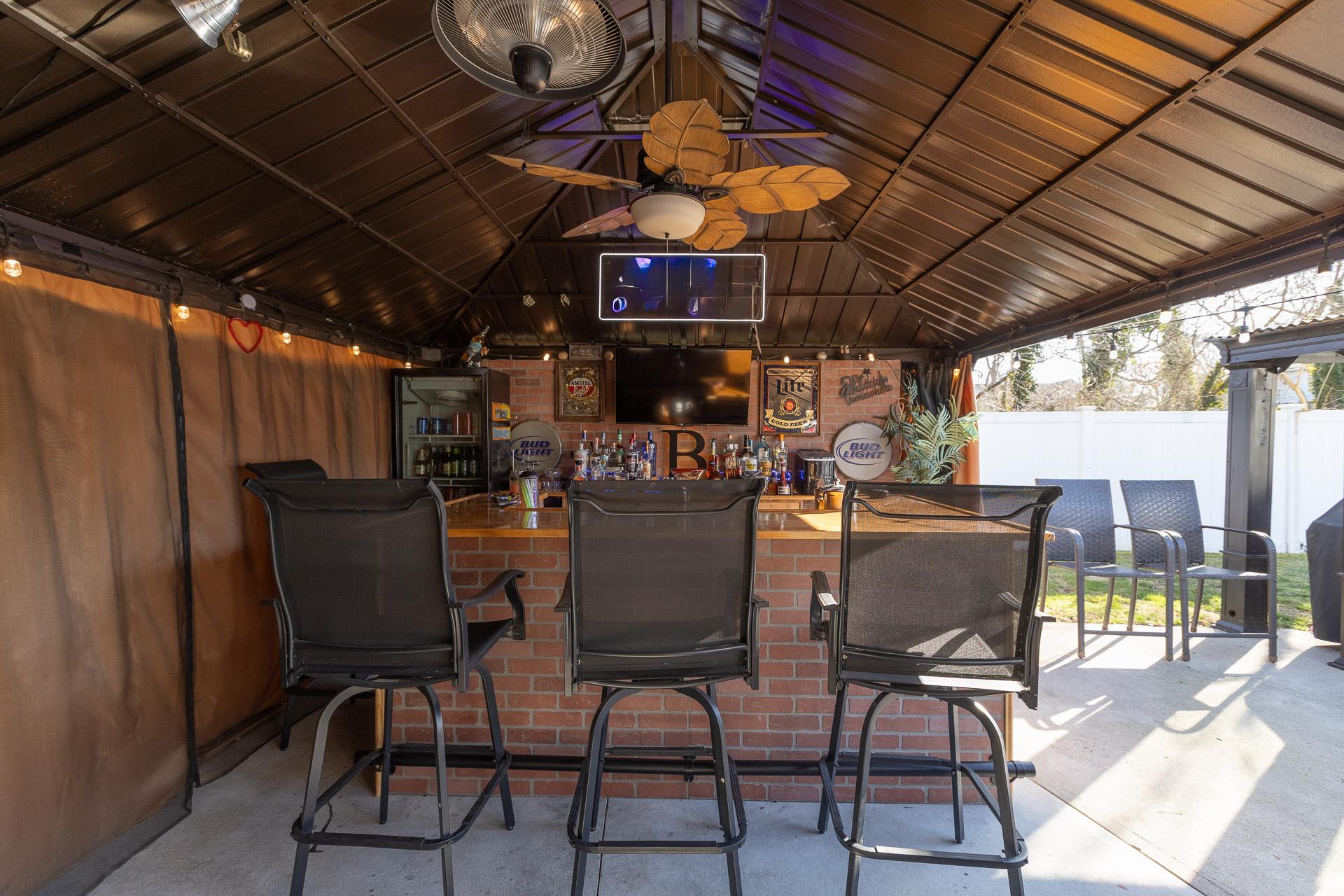 84 Riverside Avenue Mastic Beach, NY 11951 - Photo 25 of 32 View of patio featuring outdoor dry bar, a gazebo, and fence