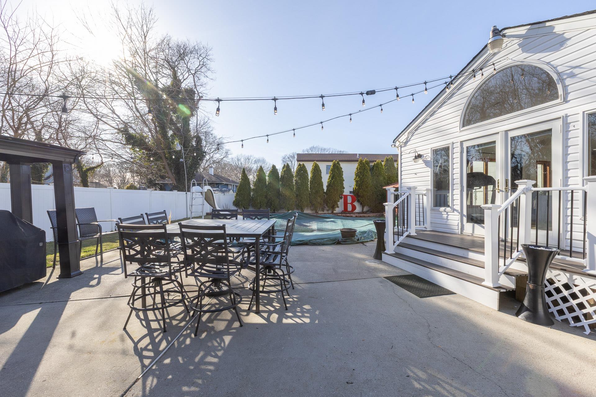 84 Riverside Avenue Mastic Beach, NY 11951 - Photo 26 of 32 View of patio / terrace with a fenced backyard, outdoor dining space, a grill, and a fenced in pool