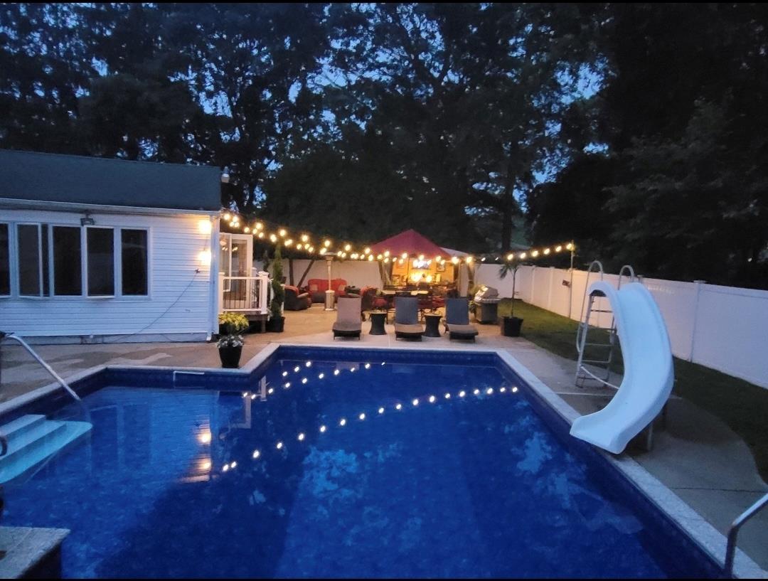 84 Riverside Avenue Mastic Beach, NY 11951 - Photo 30 of 32 View of pool with a fenced backyard, a fenced in pool, a water slide, and a patio area