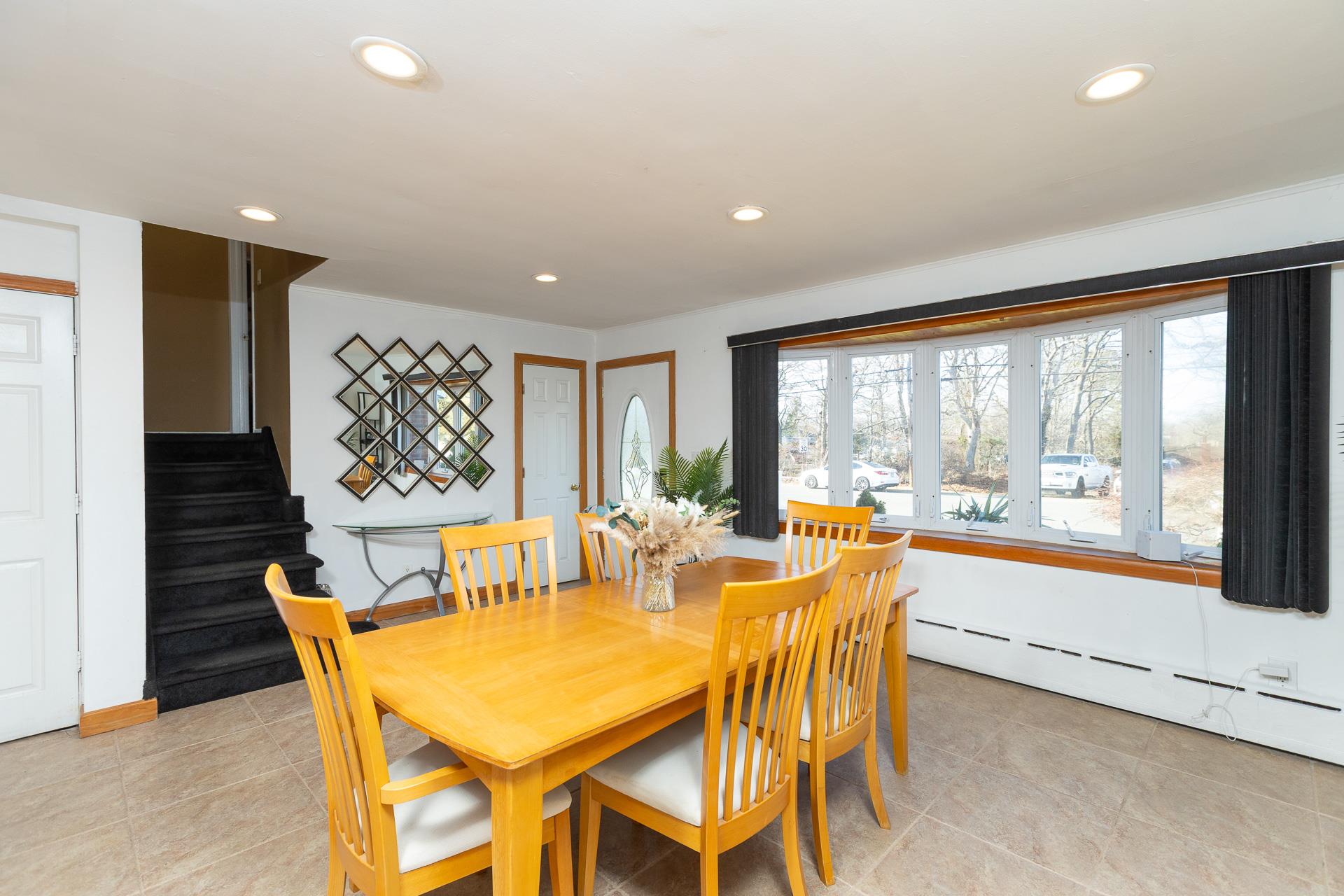 84 Riverside Avenue Mastic Beach, NY 11951 - Photo 4 of 32 Dining area with recessed lighting, a baseboard heating unit, stairway, and light tile patterned floors