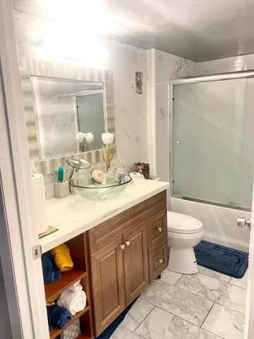 a bathroom with a toilet a sink and a mirror