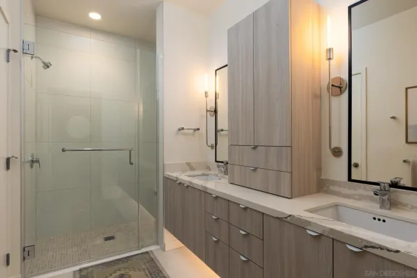 a bathroom with a double vanity sink and a mirror
